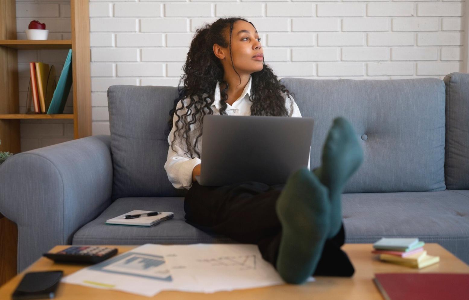Professional workspace setup showing dual monitors with financial analysis software displaying budget reports and spreadsheets